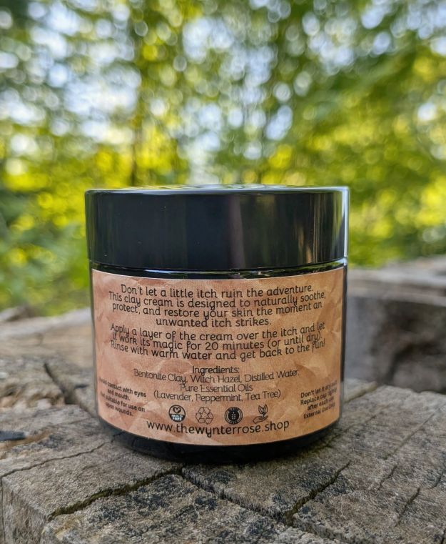 Jar of cream with a label on a stone surface with a blurred green background