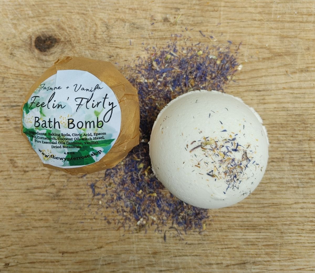 plant based jasmine vanilla Bath bomb with packaging on a wooden surface