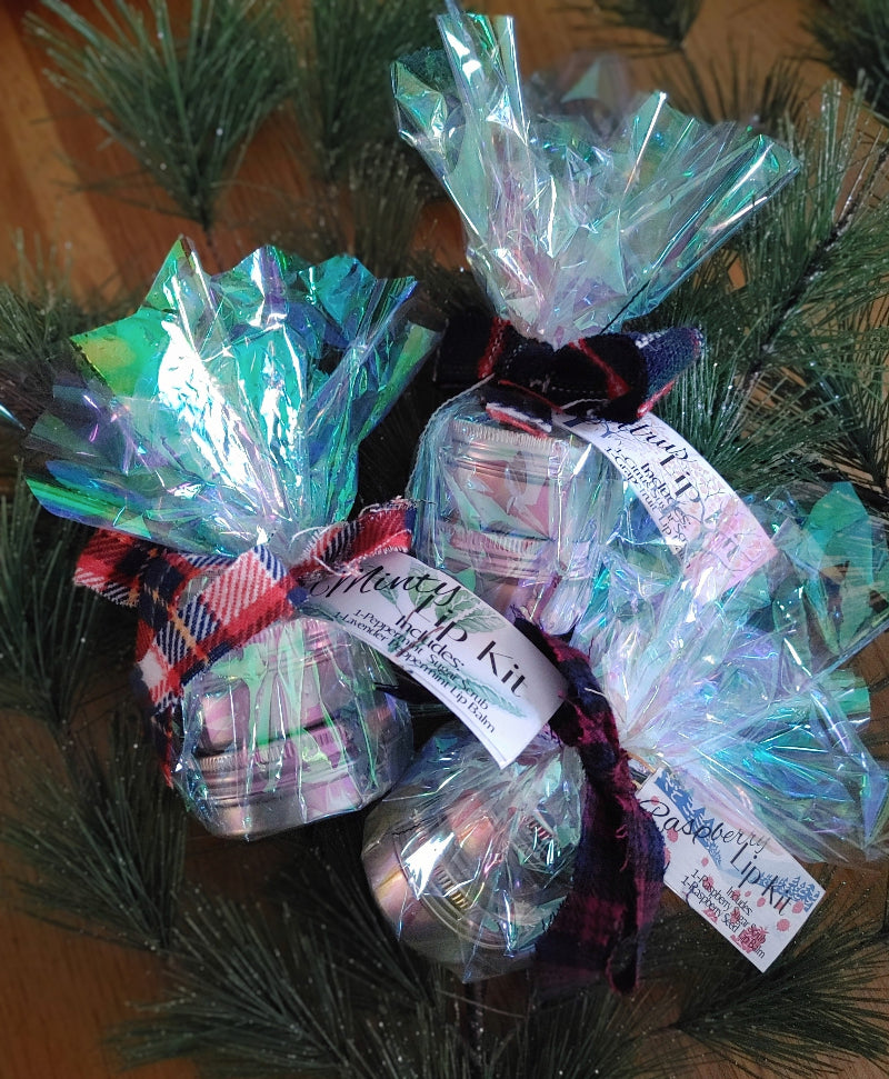 holiday lip care gift set Gift bags with ribbons and labels on a green leafy background