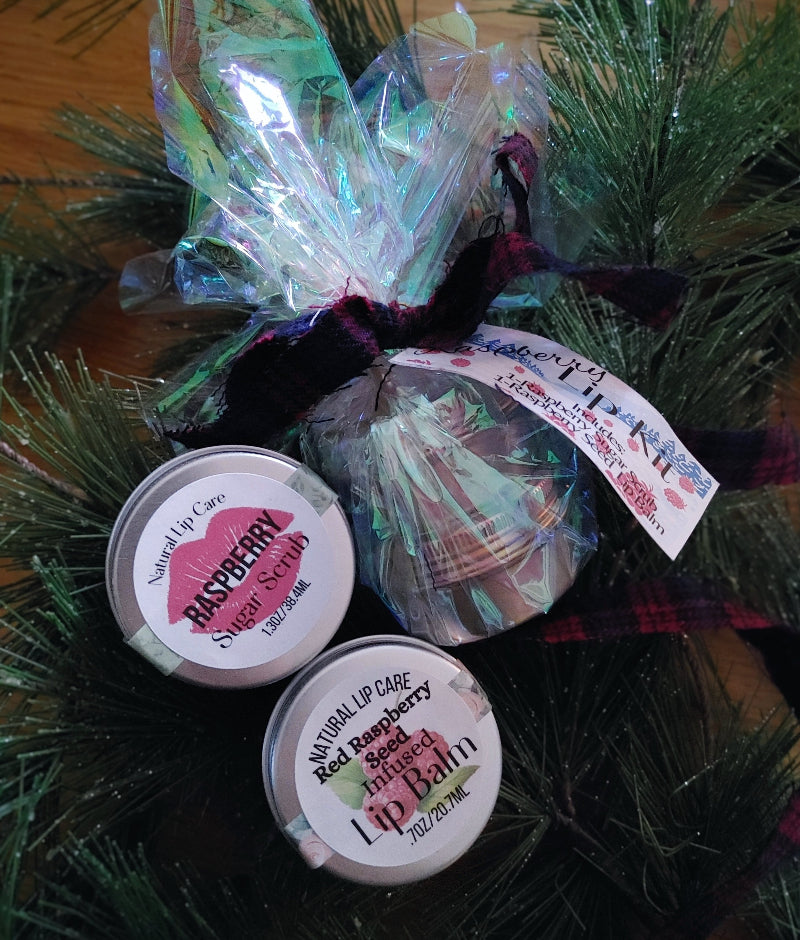 teenager stocking stuffer gift set lip scrub lip balm Two containers of raspberry sweet scrub with a decorative bow on a green background