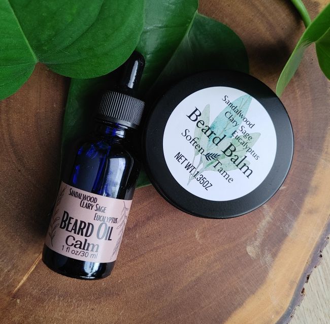 mens beard and shave collection prop picture calming beard oil beard balm laying on a wooden surface oil