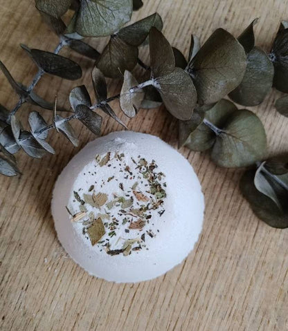 sinus relief shower steamer with natural ingredients on a wooden surface with eucalyptus leaves