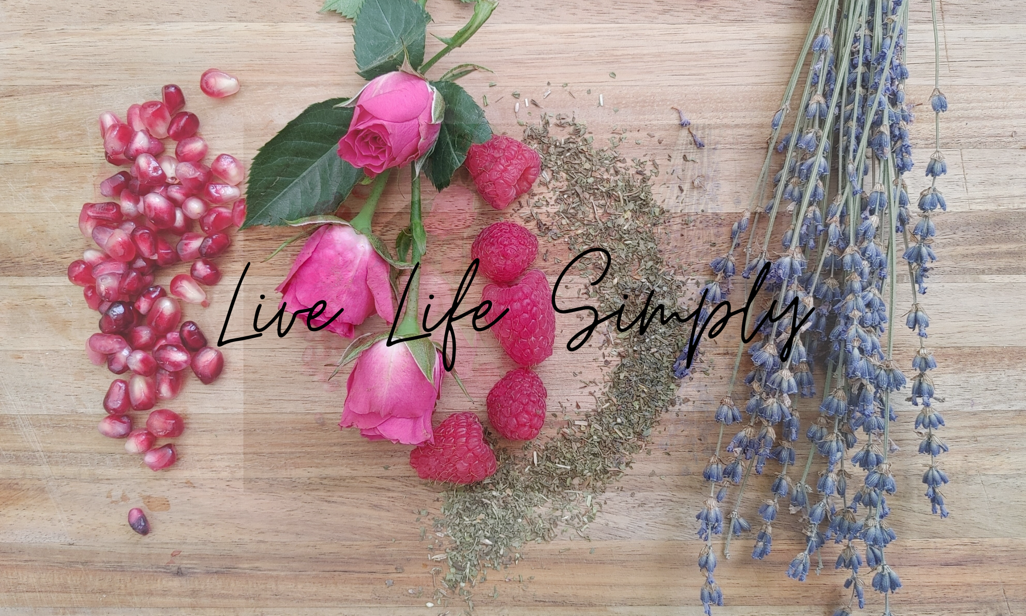 the wynter rose plant based lifestyle pomegrante roses rapsberries peppermint lavender laying on a wooden board spring collection