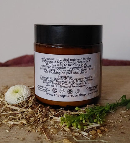 Jar of body cream with a label on a wooden surface with natural elements