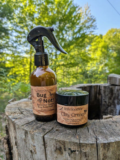 Two natural products, a spray bottle and a jar, on a wooden log with a green, leafy background.