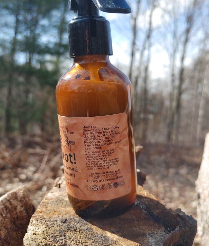 Bottle of hot sauce with a label on a wooden surface outdoors