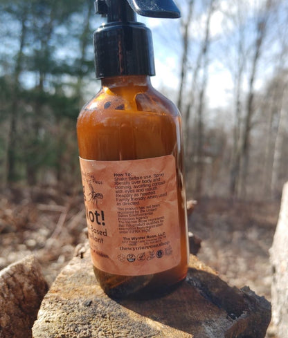 Bottle of hot sauce with a label on a wooden surface outdoors