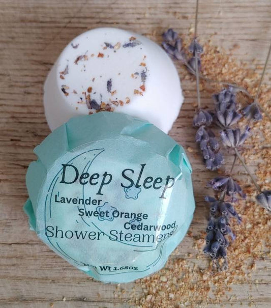Deep Sleep shower steamer with lavender and cedarwood on a wooden surface