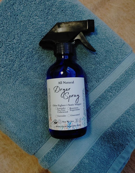 Blue bottle of all-natural dryer spray on a blue towel dryer sheet replacement anti static spray