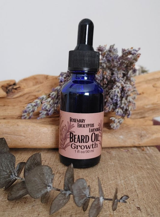 Bottle of growth beard oil with a dropper on a wooden surface with lavender flowers. rosemary infused beard care