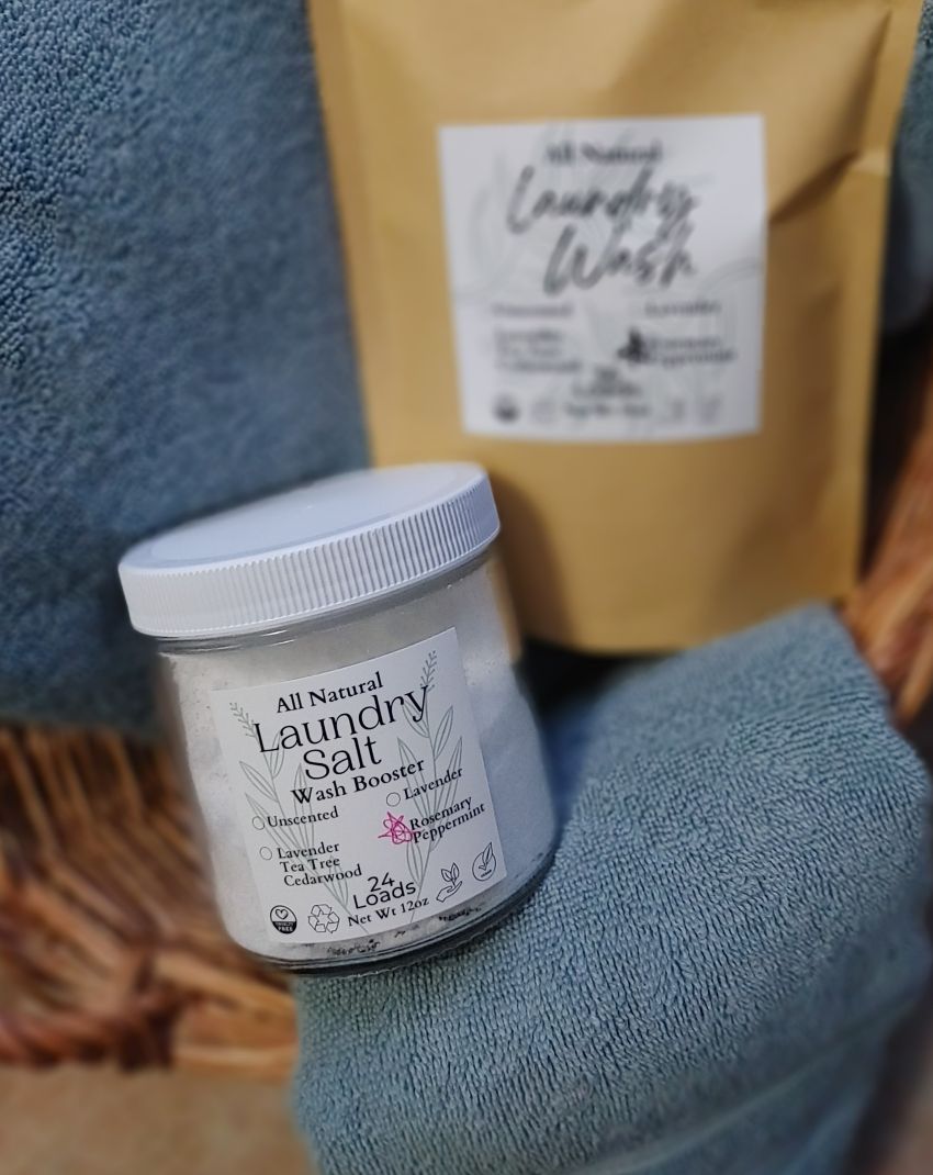Jar of all natural laundry salt and a bag of laundry wash on a blue towel. laundry booster salt