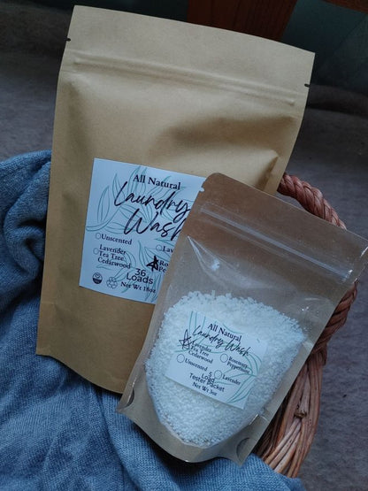 Two bags of laundry detergent, one clear and one brown, with labels on a textured surface.