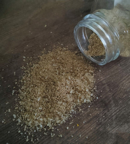 Matcha infused body soak by the wynter rose Glass jar of brown sugar on a wooden surface