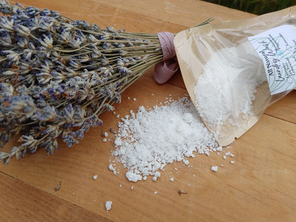 bundle of dried lavender laying on a wooden surface with Laundry Wash powder poured across the surface