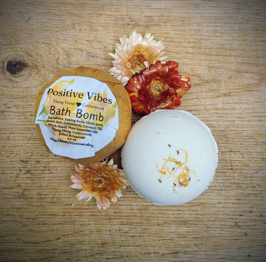 positive vibes all natural Bath bomb with a label on a wooden surface with flowers