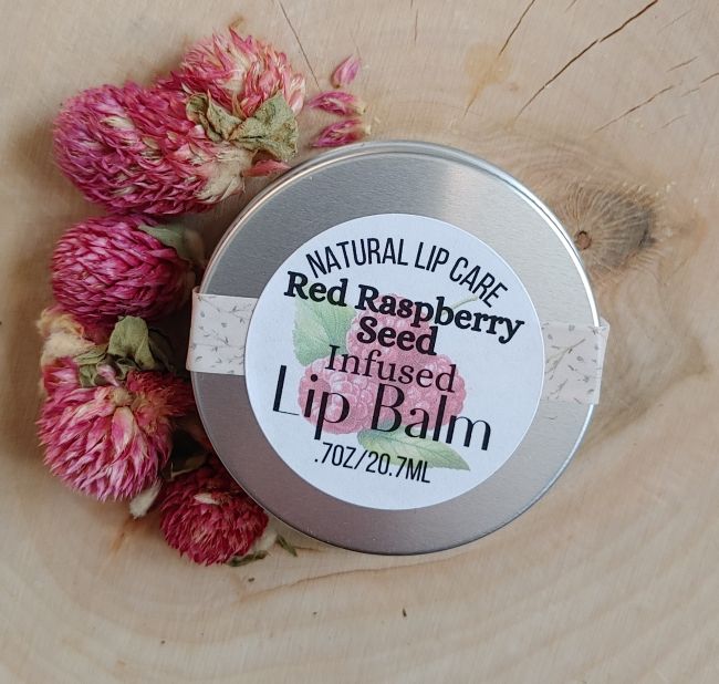red raspberry seed infused lip balm round tin on wooden surface natural lip care