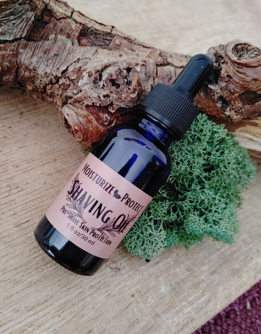 Bottle of shaving oil with a dropper on a wooden surface with moss