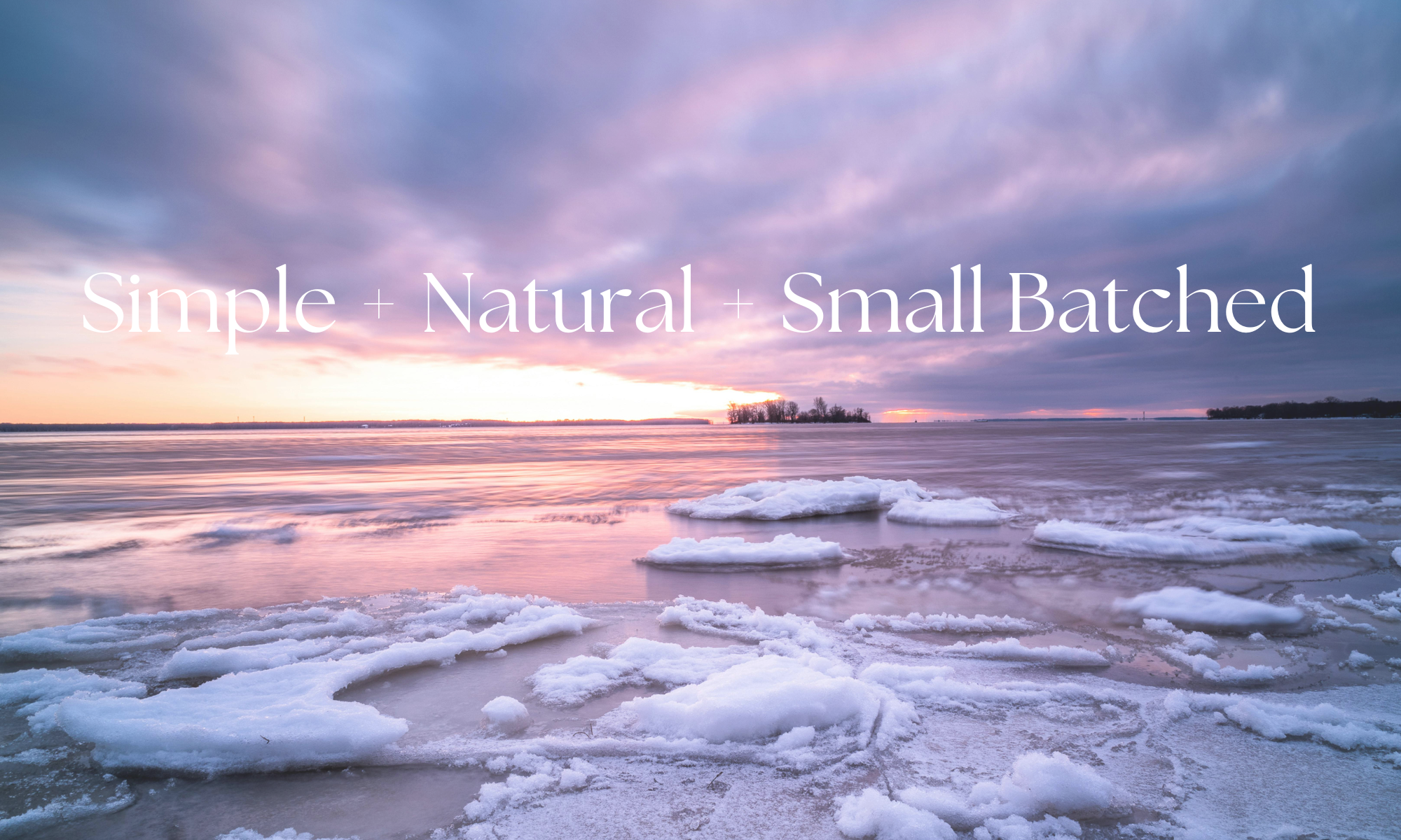 the wynter rose smalled batched plant based home and body care products on photo of a frozen lake with pink sunset
