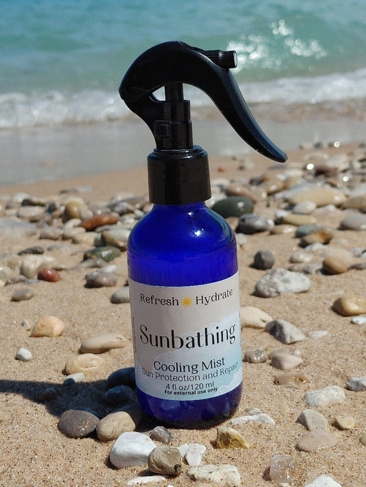 sunbathing peppermint cooling mist from the wynter rose on glen haven beach in michigan on beach stone sandy shore with fresh water waves by sleeping bear dunes