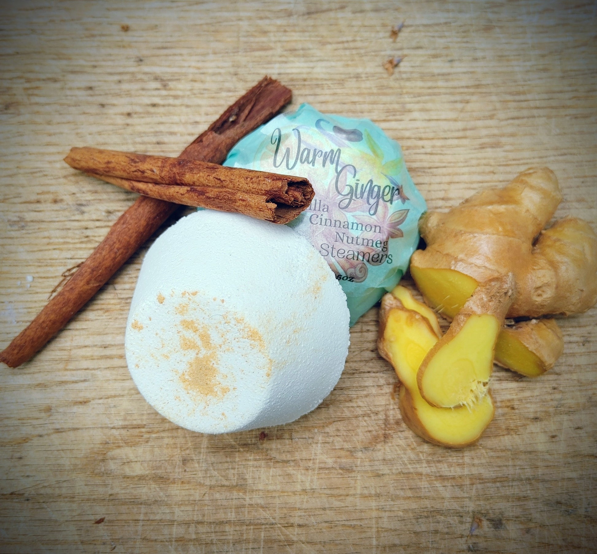 all natural shower steamer with cinnamon stick ginger and vanilla on wooden butcher block